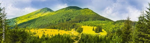 Carpathians in summer day. Mountains against the sunny blue sky with clouds on background © Stcc