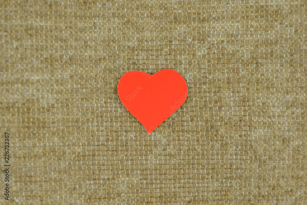 simplicity love: red heart lies on a self-sewed a linen fabric Golden brown from natural linen