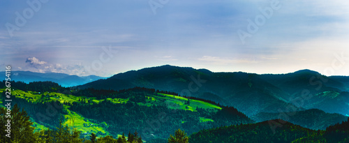 Carpathians in summer day. Mountains against the sunny blue sky with clouds on background