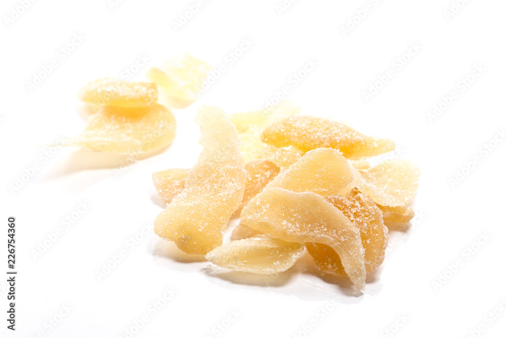 Close-up of dried ginger candy on white background Close-up of dried ginger candy on white background