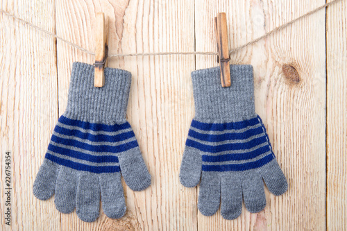 A pair of gloves on an old wooden background