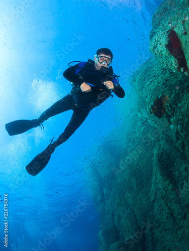 Wallpaper Mural Scuba diver underwater in the deep blue ocean and backlight sun. Torontodigital.ca