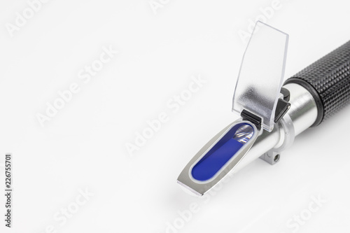 close up refractometer on white background, a laboratory or field device for the measurement of an index of refraction