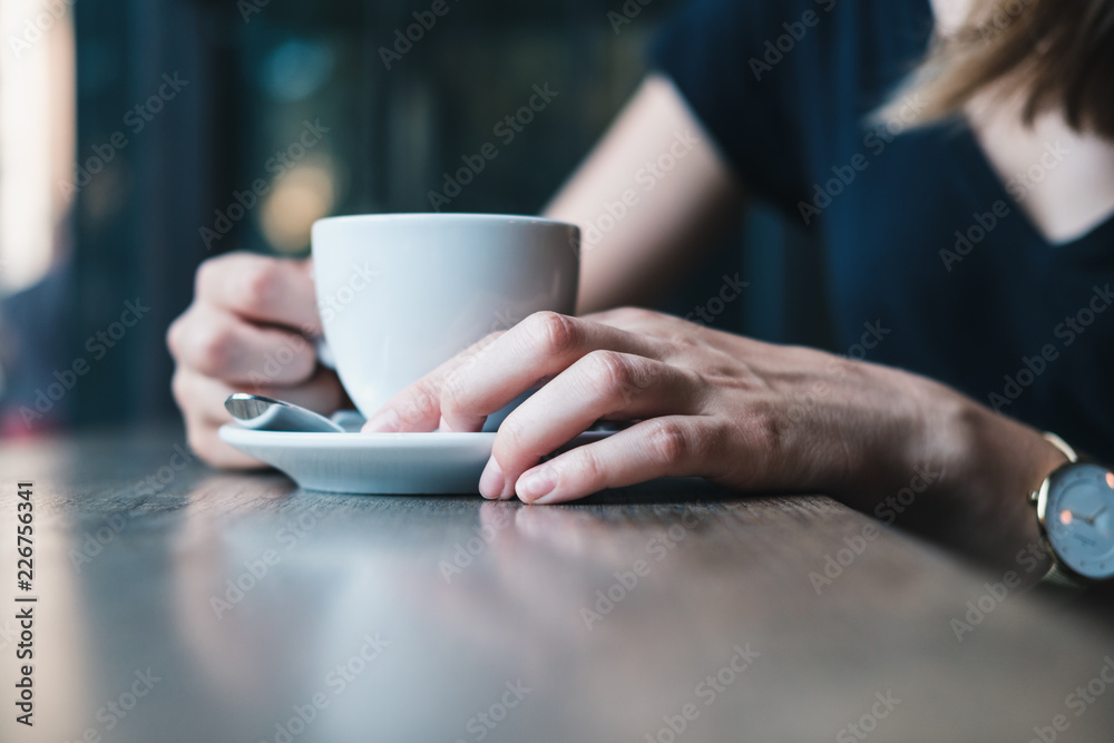 Beautiful girl's hands holding cup of coffee Beautiful girl's hands holding cup of coffee