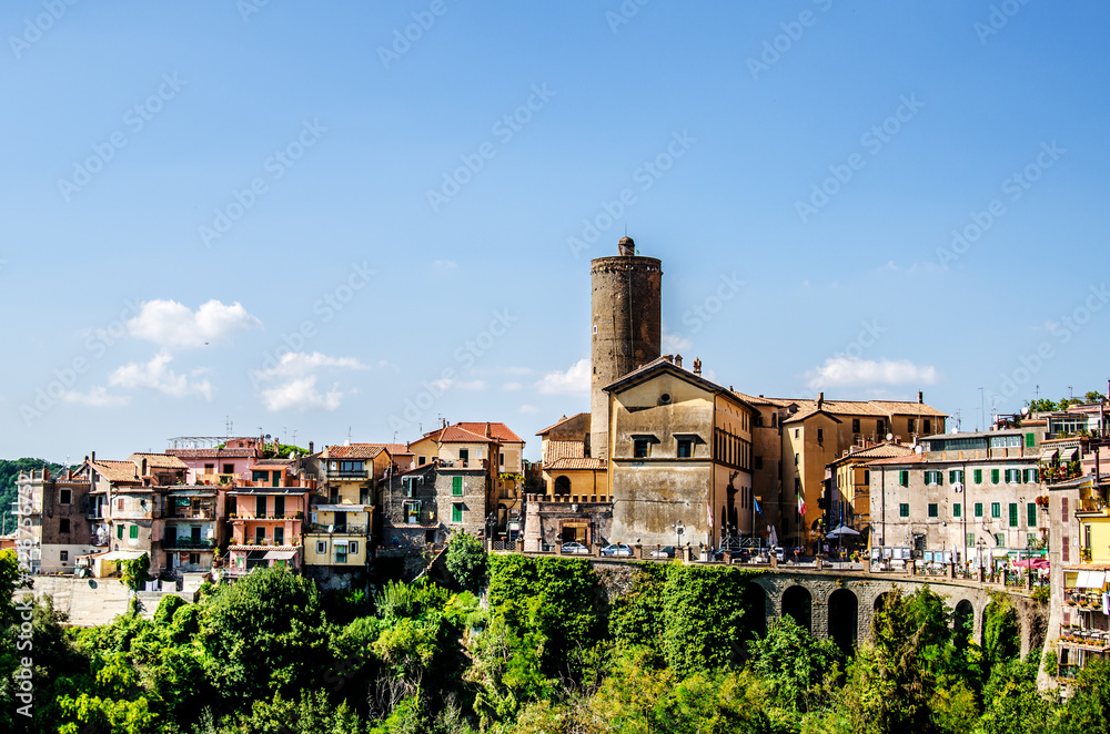 The houses of the town of Nemi, located above the cliff and the bridge leading over the cliff to the town. The surroundings of Rome. Italy.
