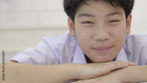 Portrait of asian child in student uniform looking at camera with smile face . 4K Slow motion of THIALAND cute boy is smile. photo