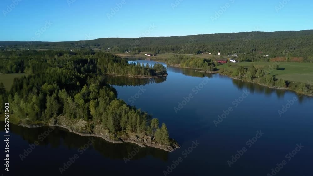 Aerial view of lake at sunset. Norwey landscape flying over lake and forest Aerial view of lake at sunset. Norwey landscape flying over lake and forest