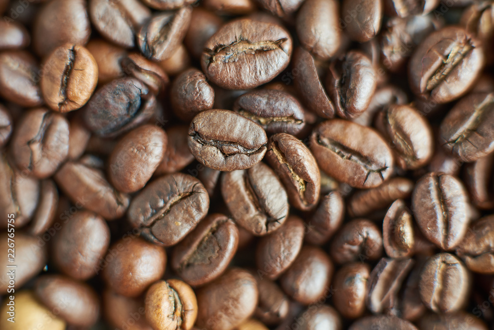 Fototapeta premium Roasted coffee beans on rustic wooden background. Food ingredients, top view, space for text
