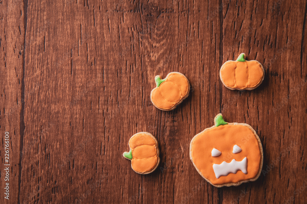 Fresh delicious homemade decorated halloween cookies sweets on dark wooden background, concept of halloween party, copy space(text space), top view, blank for text. Fresh delicious homemade decorated halloween cookies sweets on dark wooden background, concept of halloween party, copy space(text space), top view, blank for text.