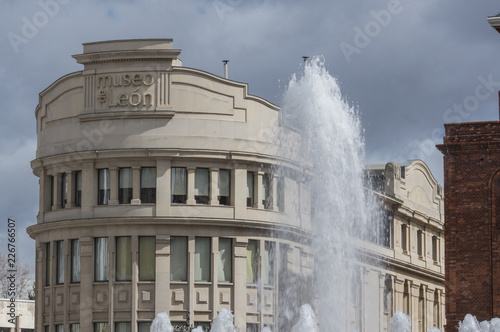 Exterior of the museum of Leon (Spain), with a dramatic sky and a fountain in the foreground. 