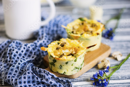 baked potato with vegetables and mushrooms and cheese on a wooden board photo