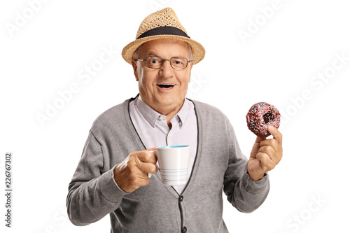 Mature man holding a cup and a donut