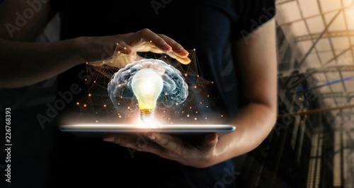 Human holding tablet with light bulb future technology, brain and network connection on communication background, science, innovation and creative idea concept.