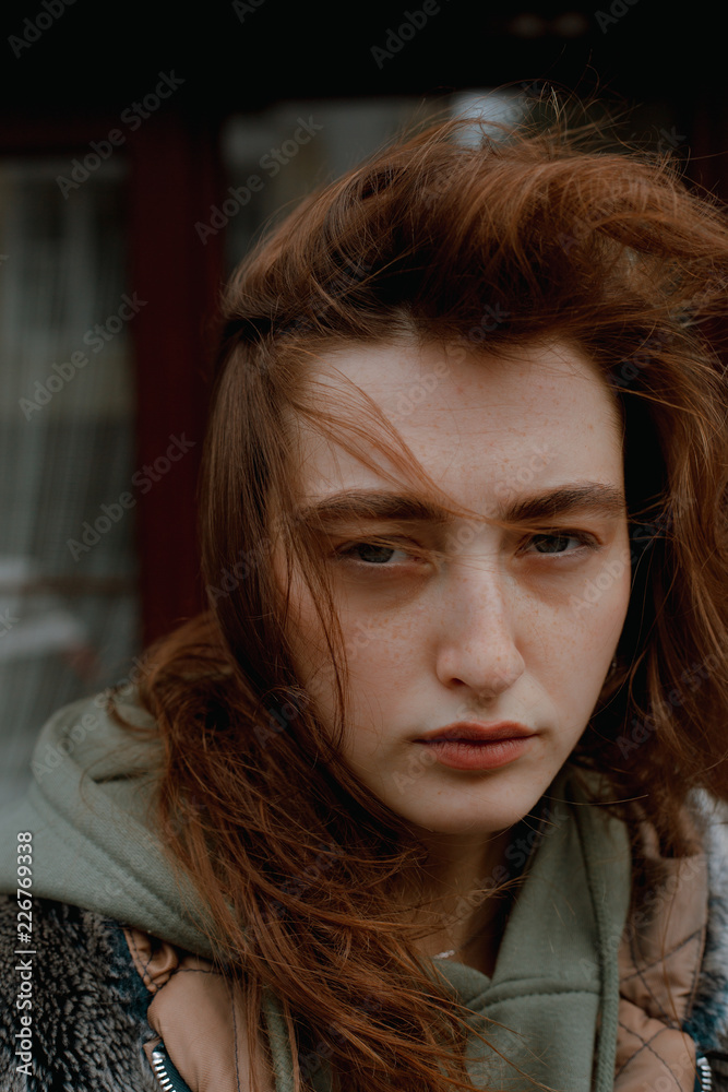 Street portrait of a beautiful and stylish girl in a fur coat, with coffee and a telephone Street portrait of a beautiful and stylish girl in a fur coat, with coffee and a telephone
