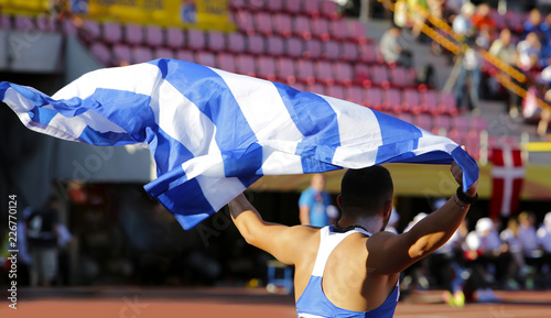 Athlete with greek flag on the stadium