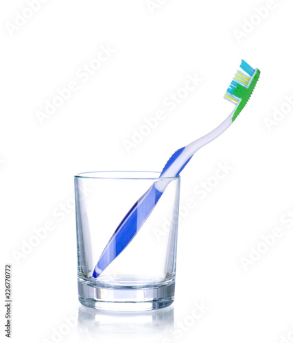 One tooth brushes in glass  isolated on white