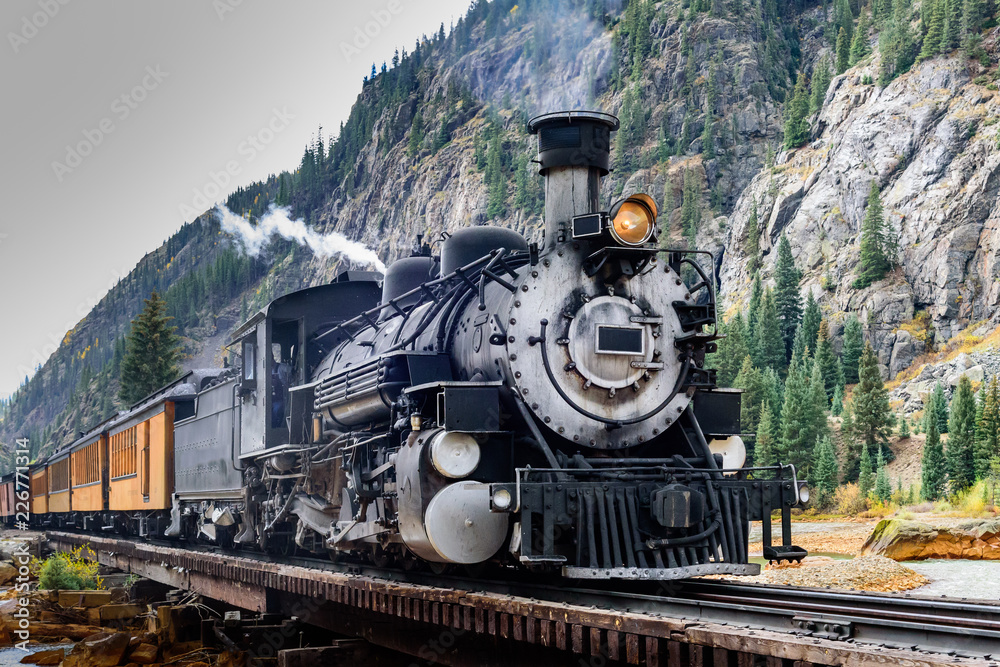 Fototapeta Vintage Steam Train Crossing a River in Colorado