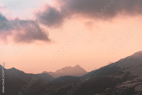 Red cloud over distant mountains
