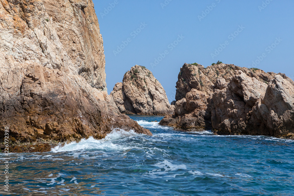 sea water splashing rocky coastline on the shores of Tossa De Mar