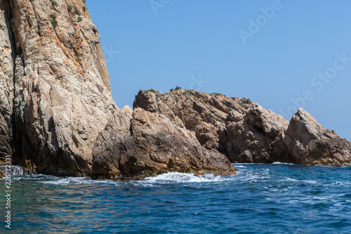 sea water splashing rocky coastline on the shores of Tossa De Mar © Daniel Samray