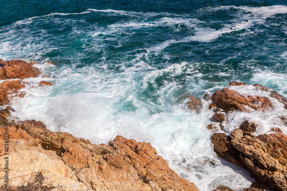 Fototapeta premium Rocks, waves and surf on Tossa de Mar beach