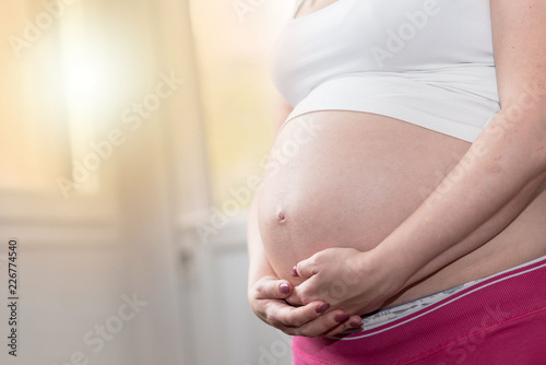 Free Download Pregnant woman with hands on her belly - GFXLoad