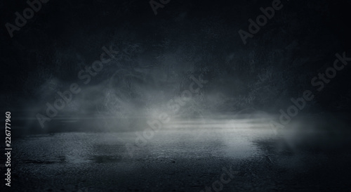 Background of an empty dark room. Empty walls, lights, smoke, glow, rays © MiaStendal