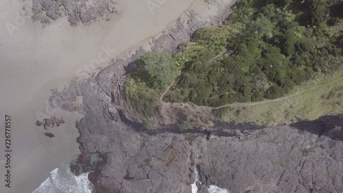 Exposed trail down to a beach on a cliff in New Zealand