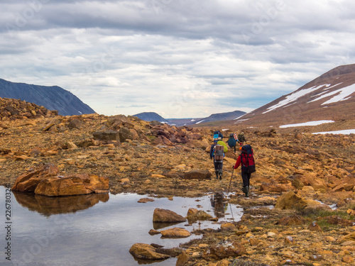 Tourists come down from the mountains. Beautiful mountain landscape, panorama. Snowy peak. Polar urals mountains. Yamal