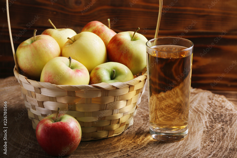apple juice with apple basket on dark background with glass of juice. autumn coming apple juice with apple basket on dark background with glass of juice. autumn coming