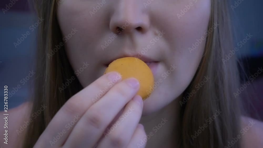 Young beautiful girl eats macaroon in super slow motion Young beautiful girl eats macaroon in super slow motion