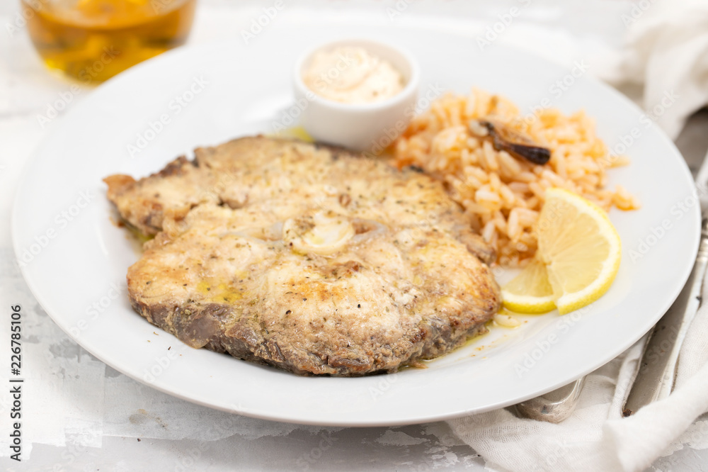fried blue shark with rice on white plate