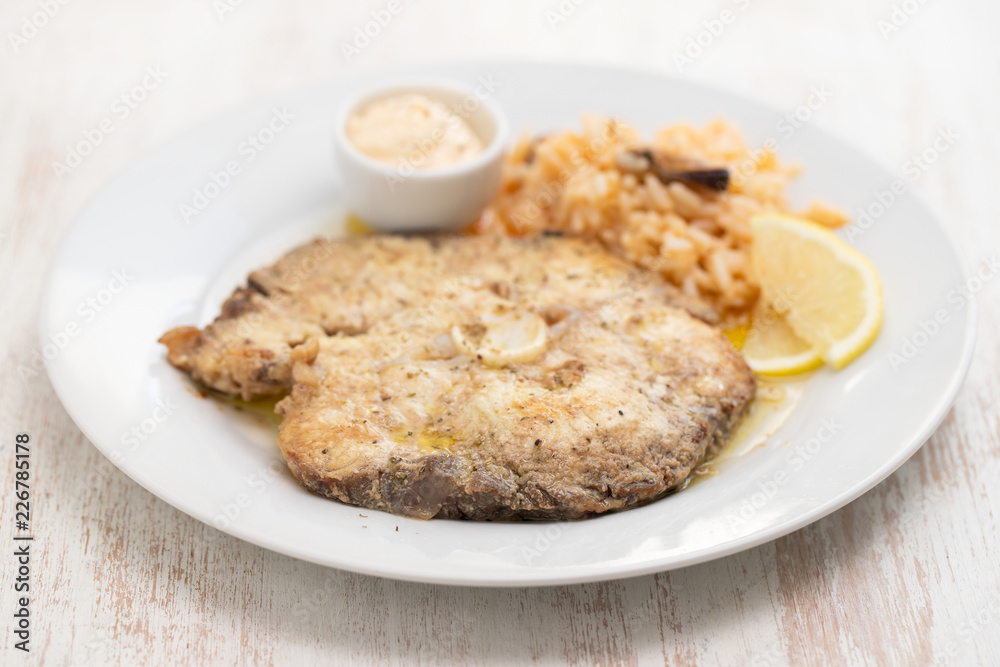 fried blue shark with rice on white plate