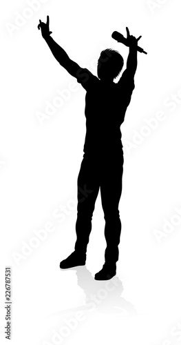 A singer pop, country music, rock star or hiphop rapper artist vocalist singing in silhouette photo