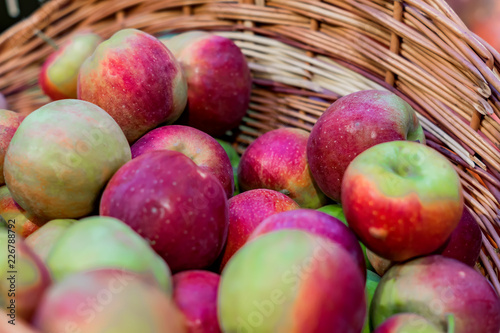 close up of red ripe apples in a basket at the farmer s market