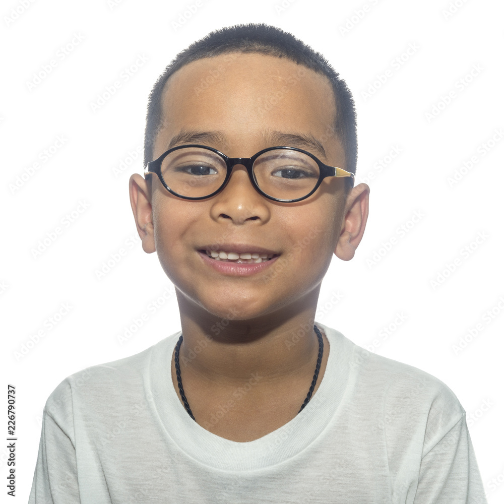 Happy boy wearing eyeglasses smiling looking at camera on white background.