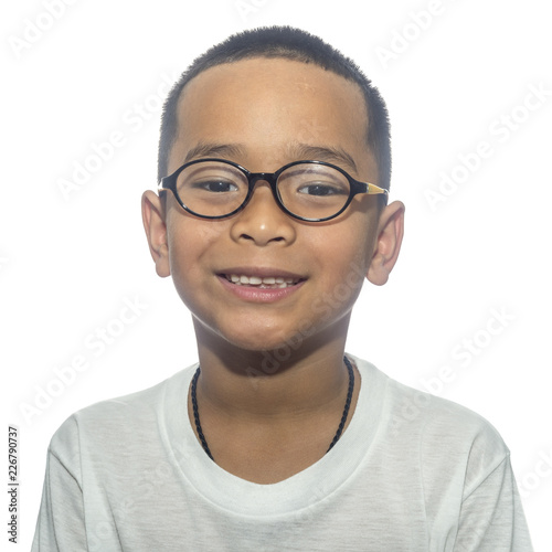 Happy boy wearing eyeglasses smiling looking at camera on white background.