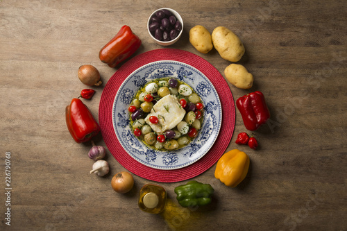 Fotografie A typical Portuguese dish with codfish called Bacalhau do Porto in a original portuguese plate
