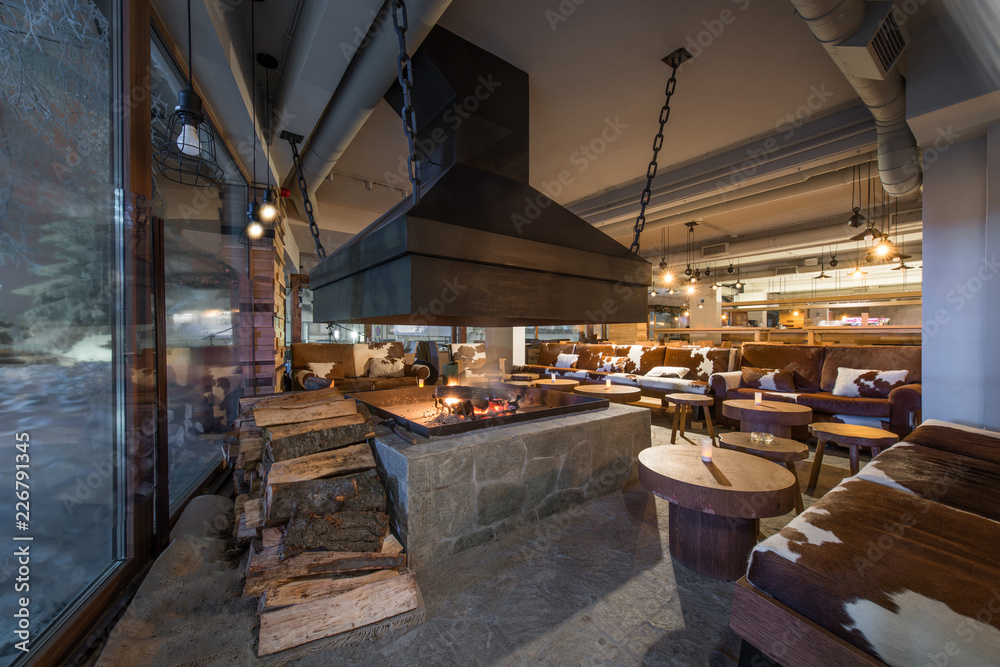 Restaurant interior with big real fireplace
