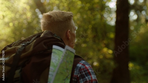 Backshot traveler portrait with huge backpack on hiking in the park