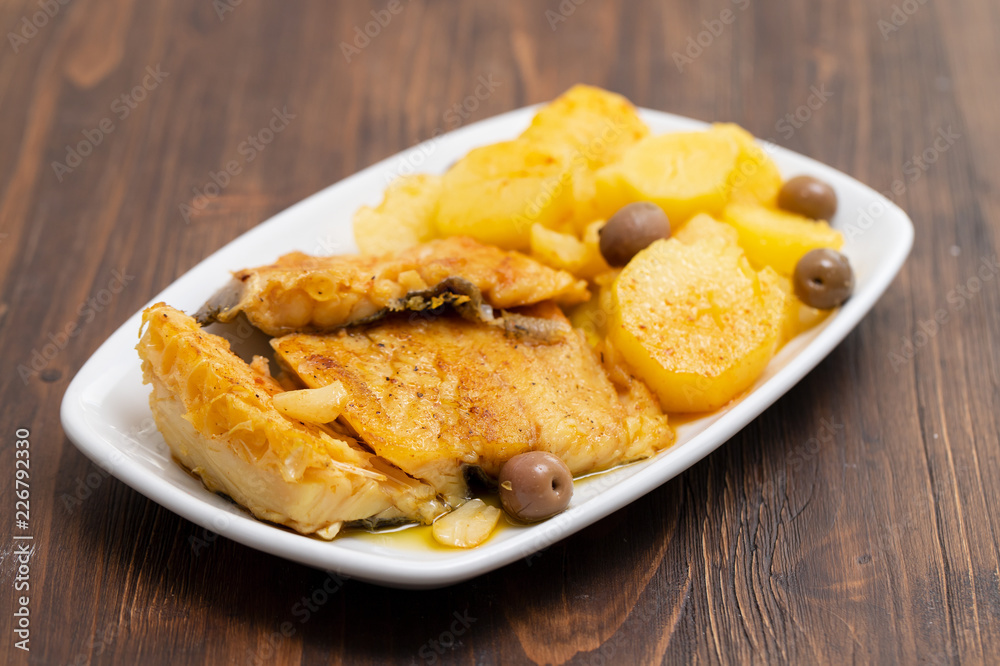 cod fish with fried potato on white dish cod fish with fried potato on white dish