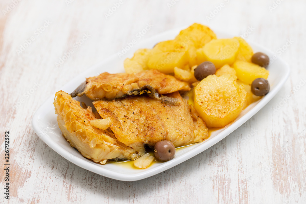 cod fish with fried potato on white dish cod fish with fried potato on white dish