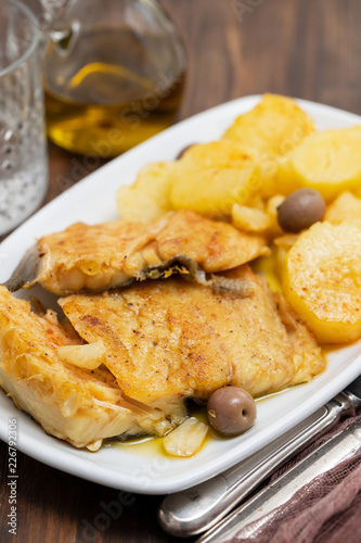 cod fish with fried potato on white dish