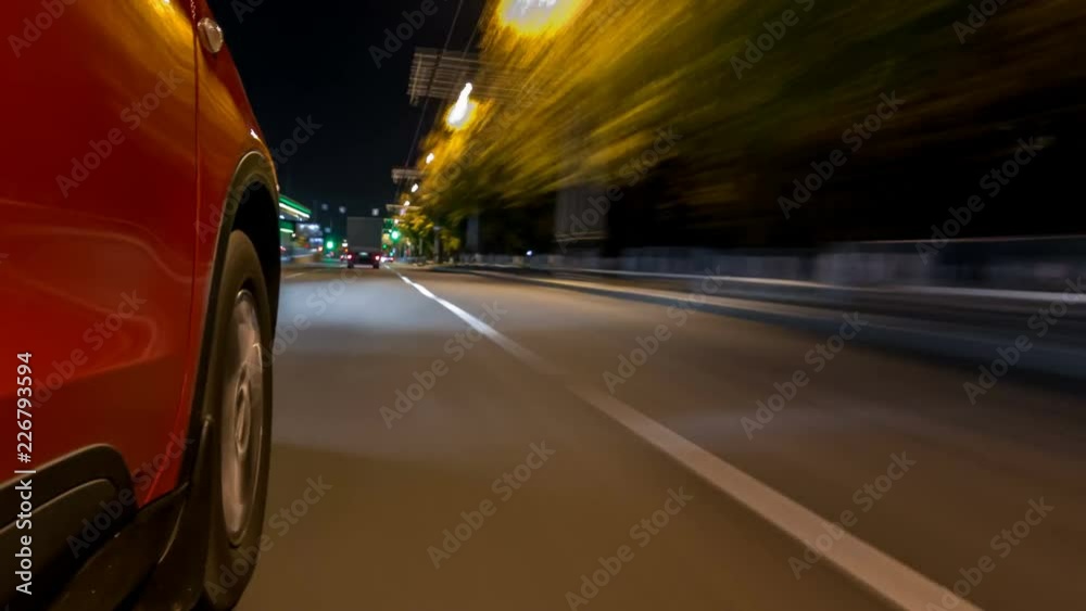 Drivelapse from side of car moving on a night avenue in city timelapse hyperlapse