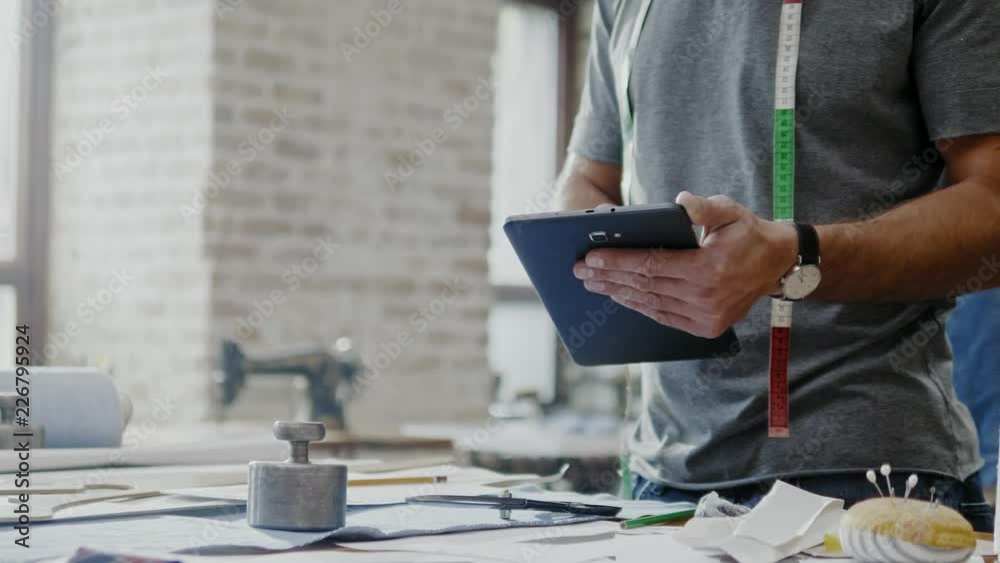 Fashion designer working in his studio Fashion designer working in his studio