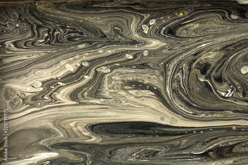 Gold marbling texture design. Black and golden marble pattern. Fluid art. © anya babii