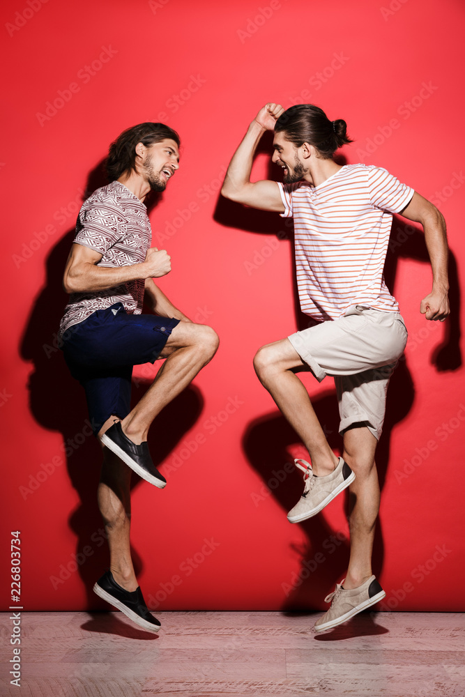 Full length portrait of a two young happy twin brothers Full length portrait of a two young happy twin brothers