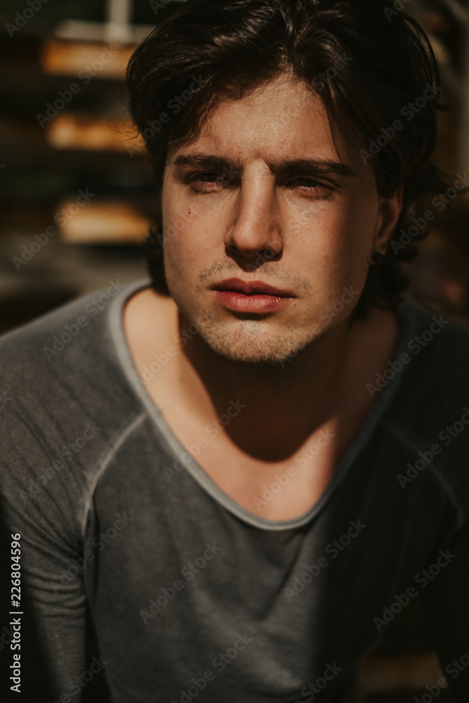 Portrait of a handsome man with face in the sunlight Portrait of a handsome man with face in the sunlight