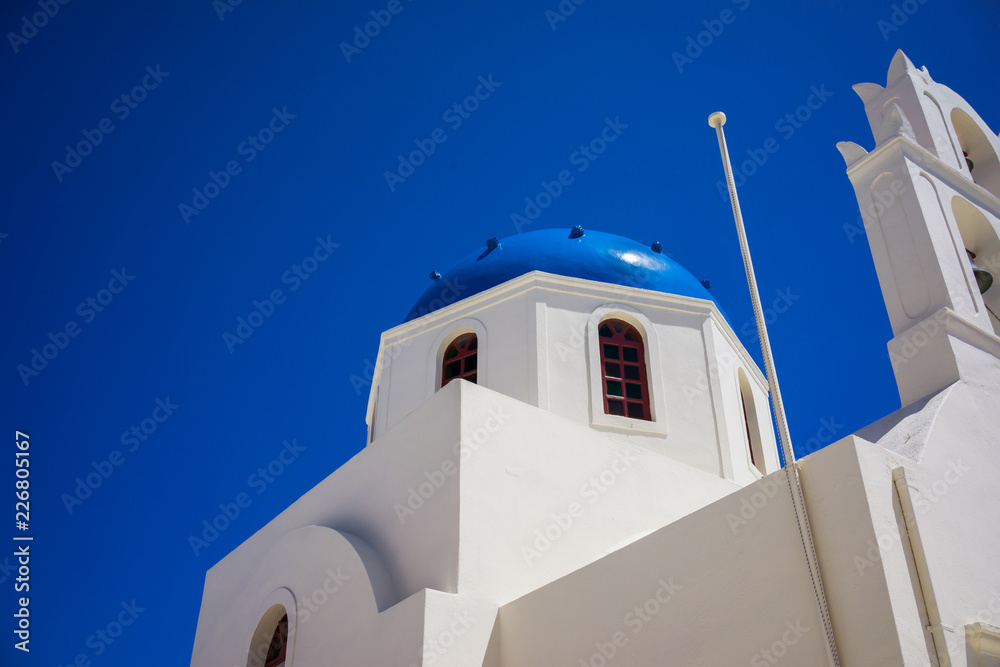 A church in Oia, Santorini, Greece set against a deep blue sky