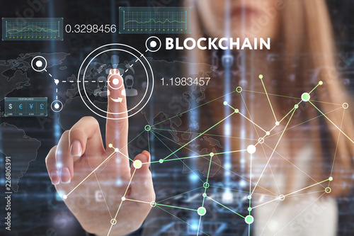 The concept of business, technology, the Internet and the network. A young entrepreneur working on a virtual screen of the future and sees the inscription: blockchain
